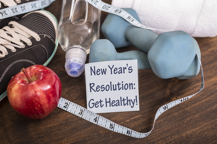 New years sign, apple, and tape measurer