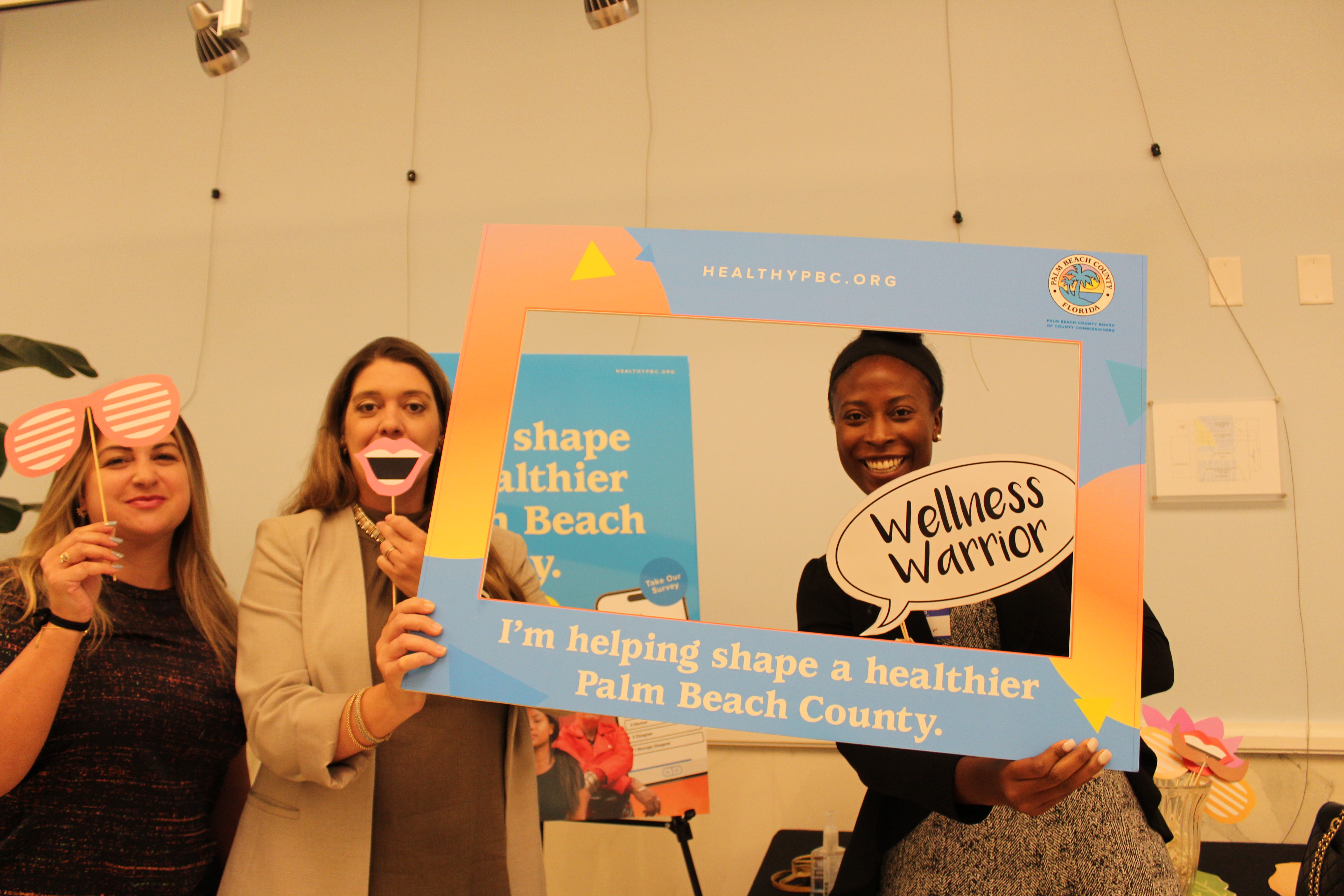 Keynote speaker Jennifer Webb strikes a pose with two event attendees in support of Shaping a Healthier Palm Beach County