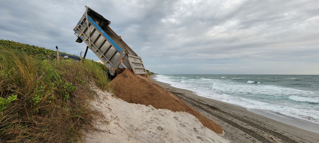 Sand beind delivered to Coral Cove beach for dune restoration