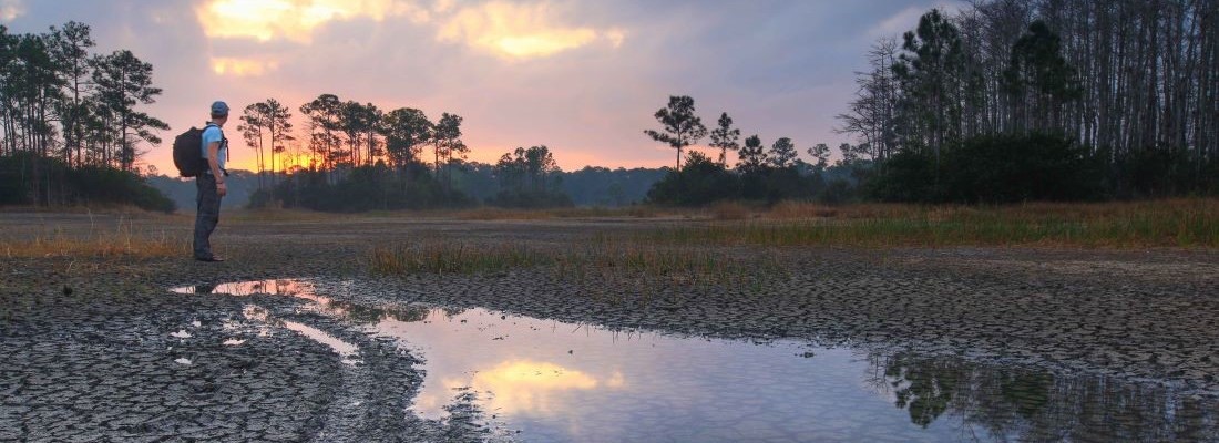Person standing at the river headwaters in Loxahatchee Slough Natural Area