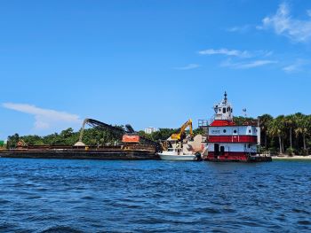 Contractor loading sand onto barge at Peanut Island