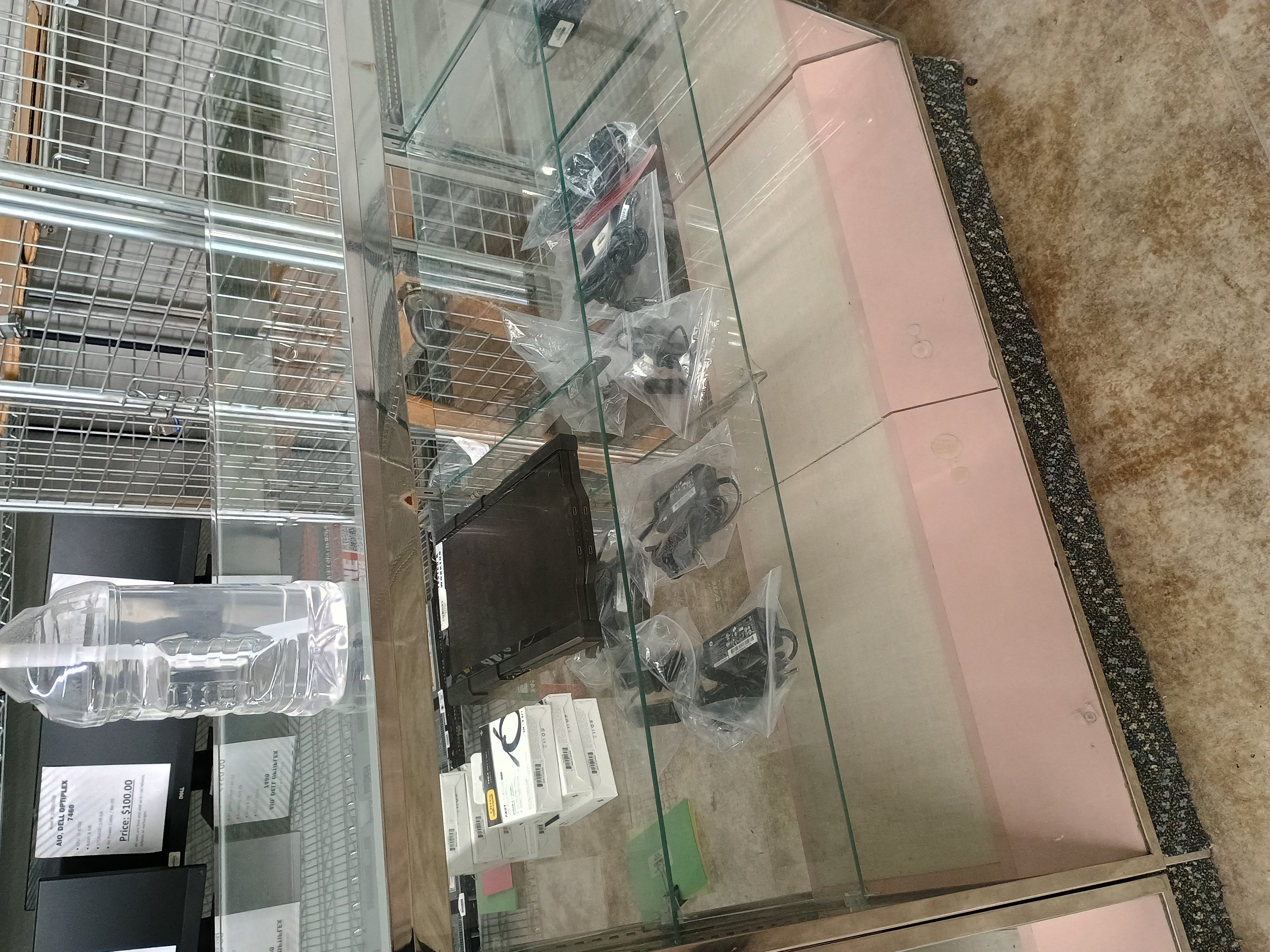 Various miscellaneous electronics and accessories inside glass display counter.jpg