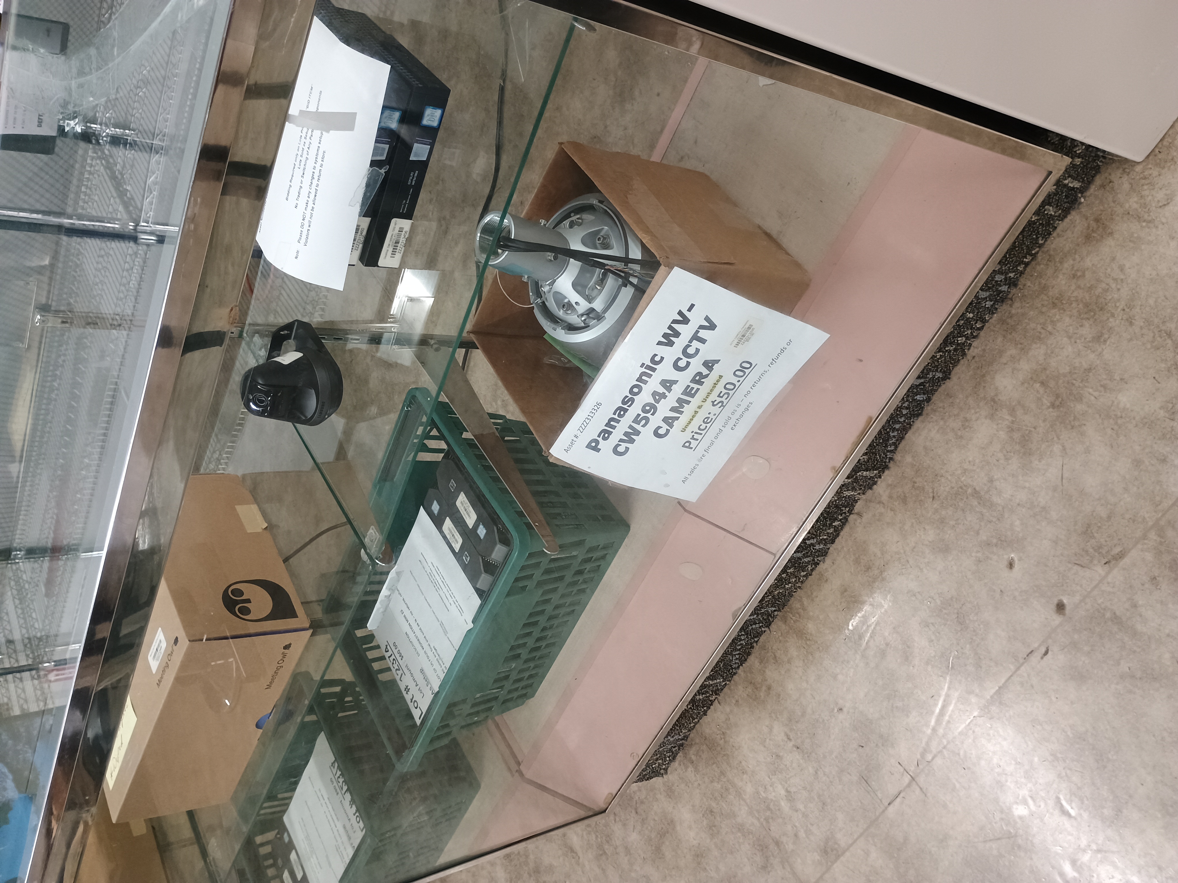 Various miscellaneous electronics inside glass display counter.jpg