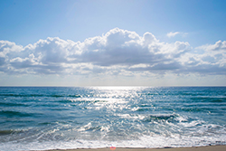 view of the water and clouds at the beach