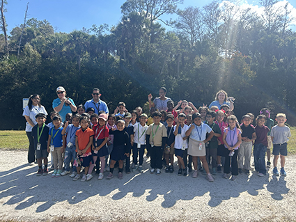 group of kids and adults smiling for a photo