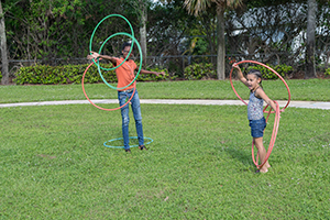 Two girls playing with hoola hoops
