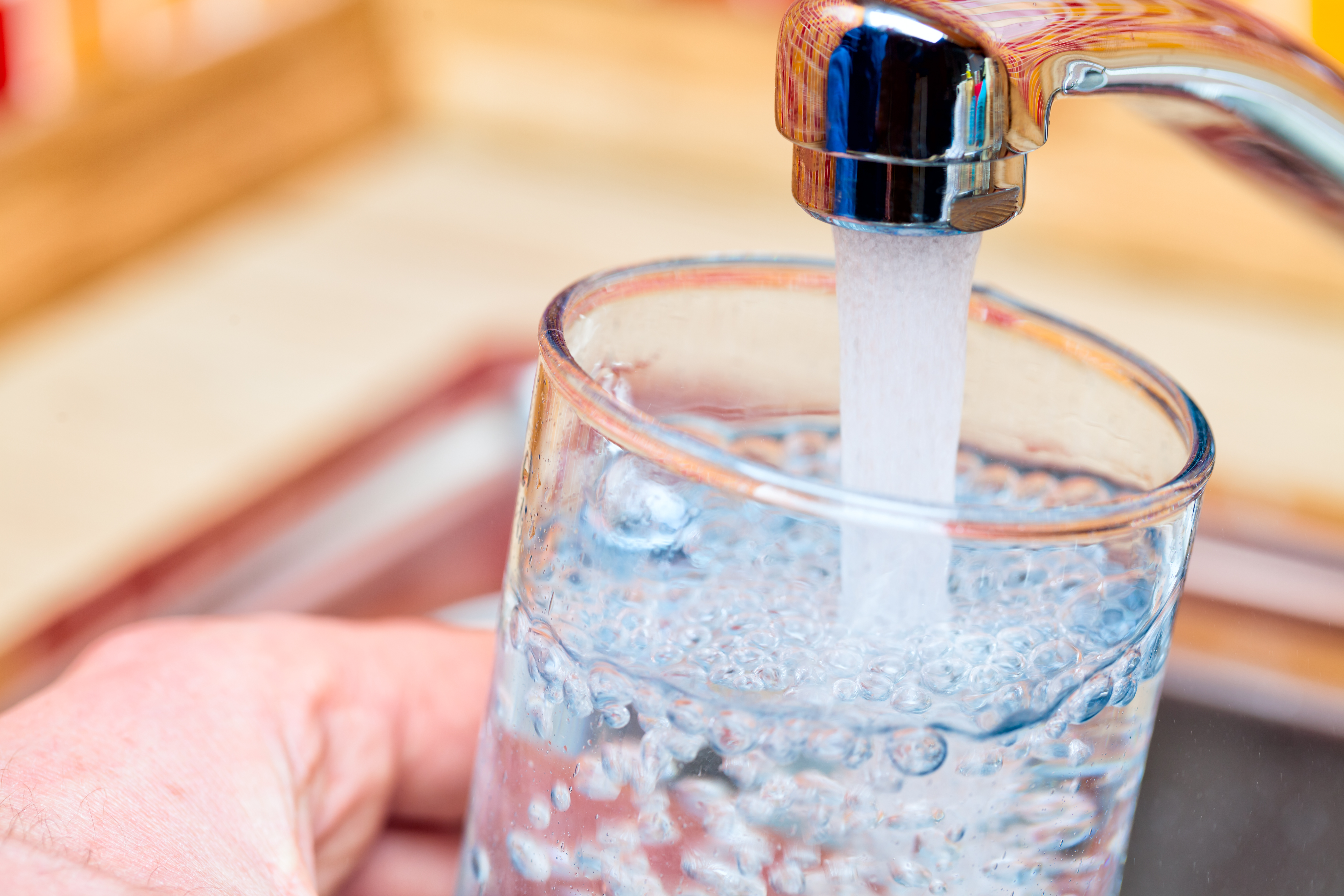 glass of water being filled at tap
